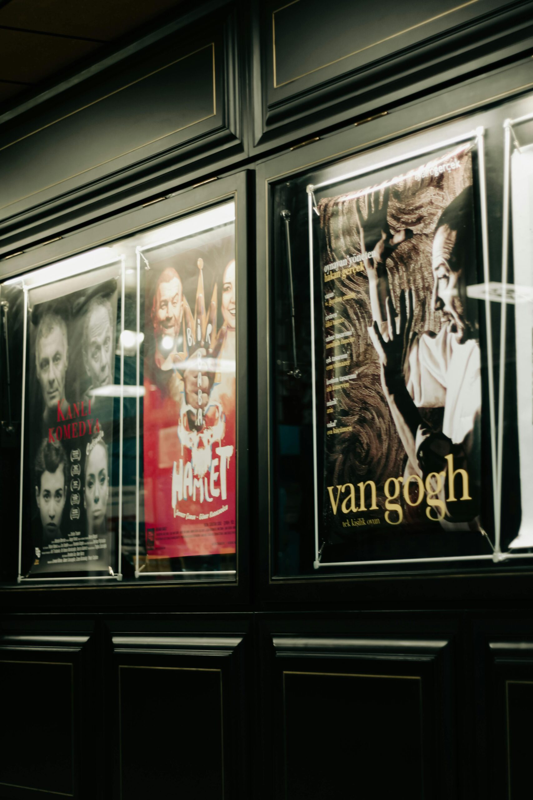 pexels photo 12838778 12838778 A collection of movie posters displayed on a sleek dark wall, creating a stylish interior vibe.