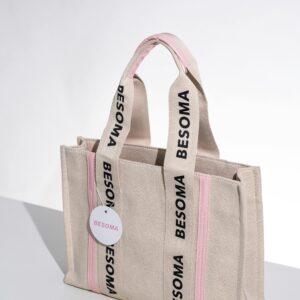 Chic Besoma tote bag with pink accents on a white backdrop, perfect for fashion shoots.