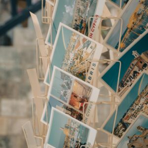 Rack of vibrant Cyprus postcards showcasing scenic views and landmarks.
