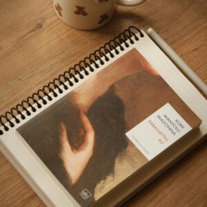 A cozy setup with coffee and a book on a wooden table, perfect for relaxation.