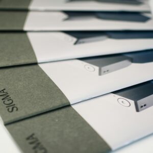 Close-up of folded Sigma brochures showcasing product images and design, ideal for marketing.