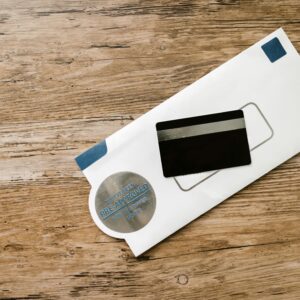 A blank credit card with a pre-approved envelope on a wooden table, showcasing financial opportunities.